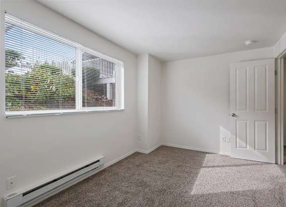 A room with a window and a door.