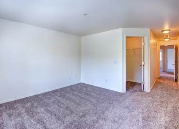 A room with carpeted floor and white walls.