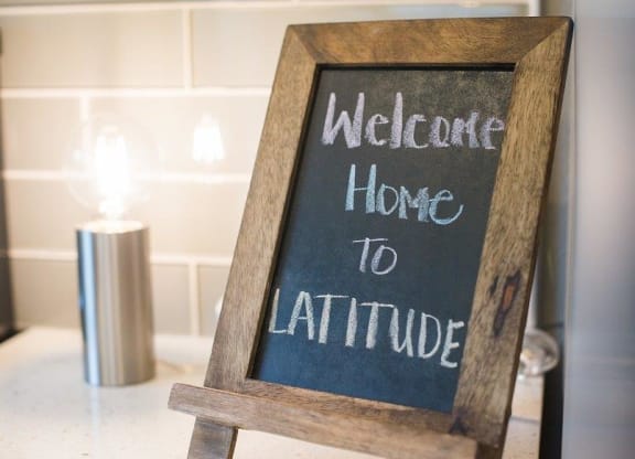 Latitude Apartments and Townhomes Welcome Home Sign
