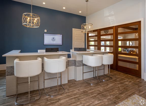 a salon with blue walls and white chairs