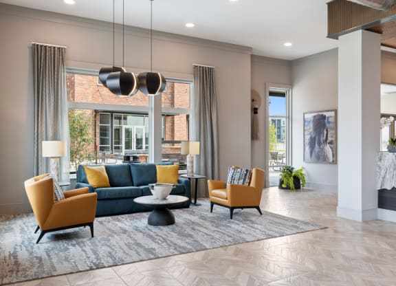 a living room with a blue couch and two yellow chairs