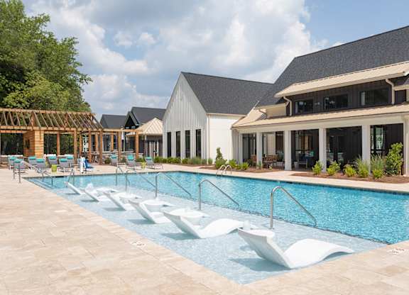 A large swimming pool with a white diving board.