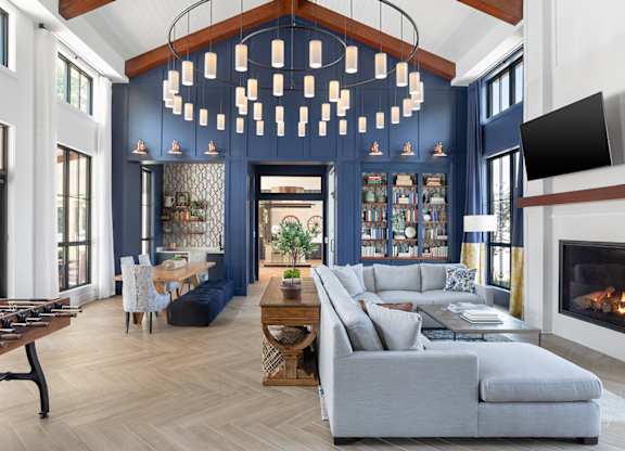 A modern living room with a fireplace and a large sofa.