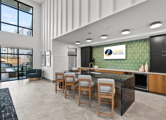 a communal kitchen and dining area in a hotel lobby