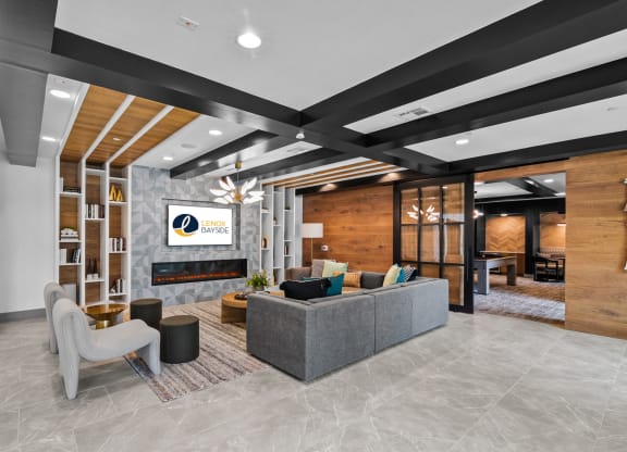 a lobby with a couch and chairs and a fireplace