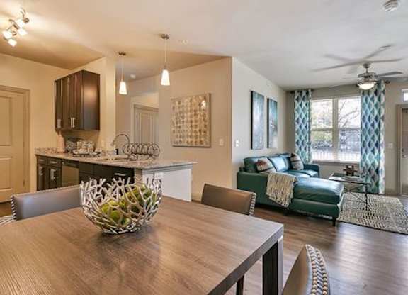 A modern dining room with a wooden table and chairs.
