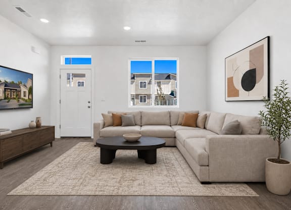 A living room with a couch, coffee table, and a painting on the wall.