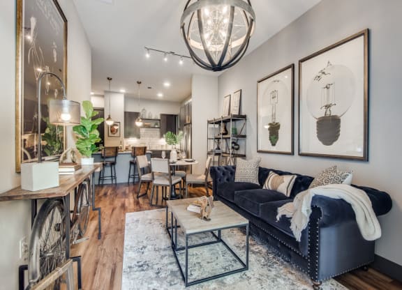 a living room filled with furniture and a large chandelier
