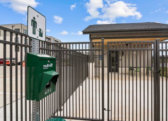 a metal fence with a green parking lot