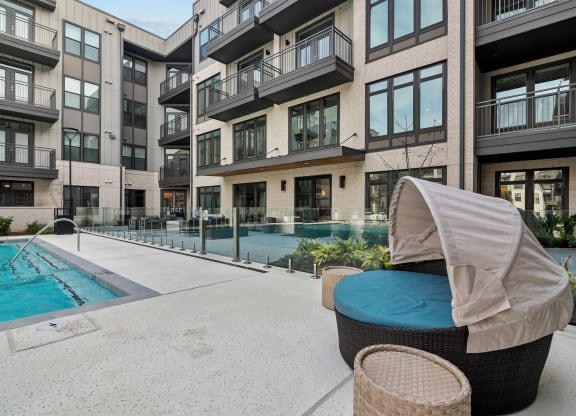 a swimming pool in front of an apartment building