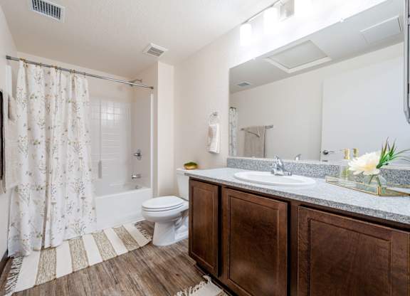 A bathroom with a toilet, sink, and shower.