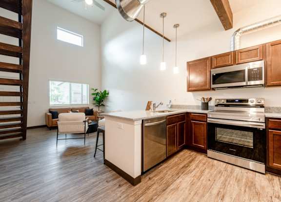 A modern kitchen with wooden cabinets and a white island.