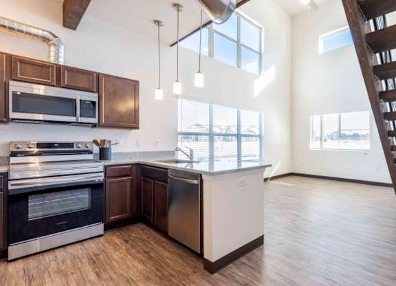 A modern kitchen with wooden cabinets and a stainless steel dishwasher.