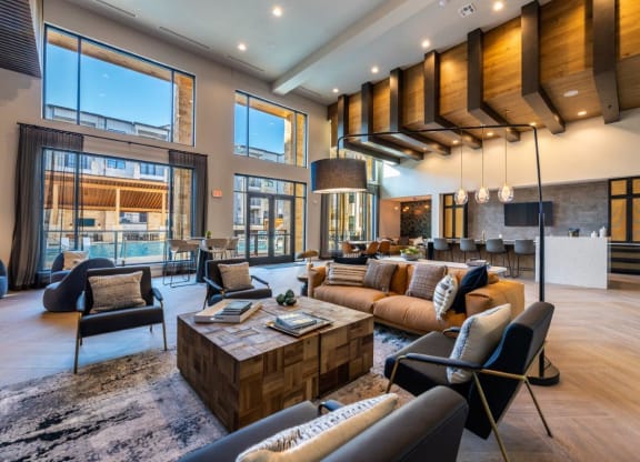 a large living room with couches and chairs and a table