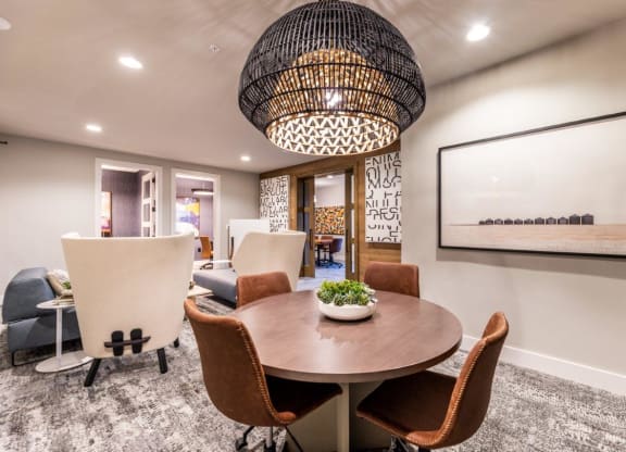 a dining room with a table and chairs and a large chandelier