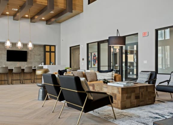 a living room with a couch and chairs and a table
