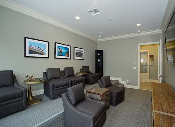 A living room with grey couches and a television.