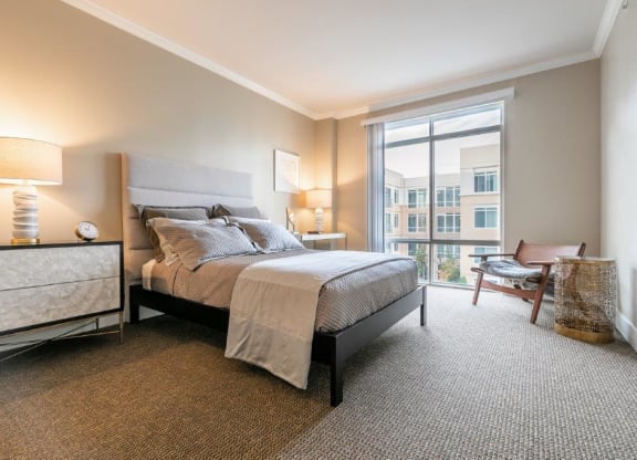 The Mercer Master Bedroom with bed, chair, and window