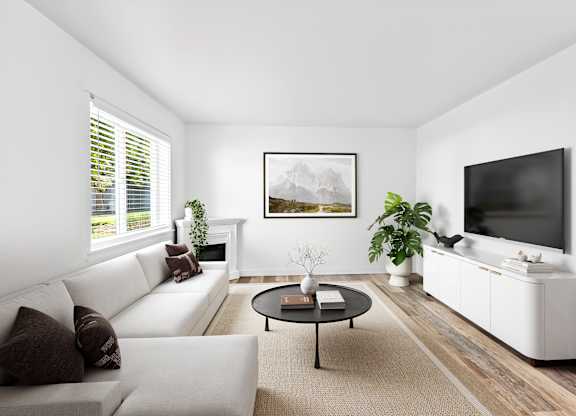 A living room with a white couch, a coffee table, and a painting on the wall.