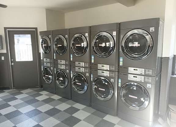 A row of washing machines in a Overlook at Pantano's Laundry Room