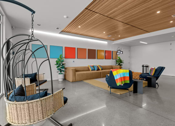 a living room with couches and chairs and a swing