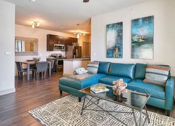 A living room with a blue couch and a coffee table.