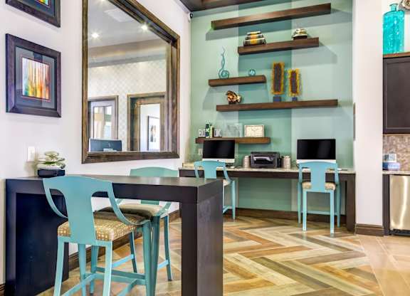 A dining room with a table and chairs.