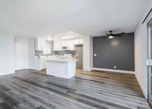 A spacious kitchen with white cabinets and a large island.