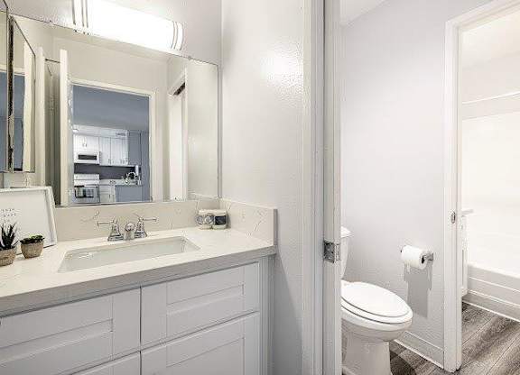 A white bathroom with a toilet and sink.