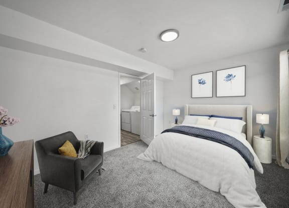 a bedroom with a medium sized bed and a chair in front of a window
