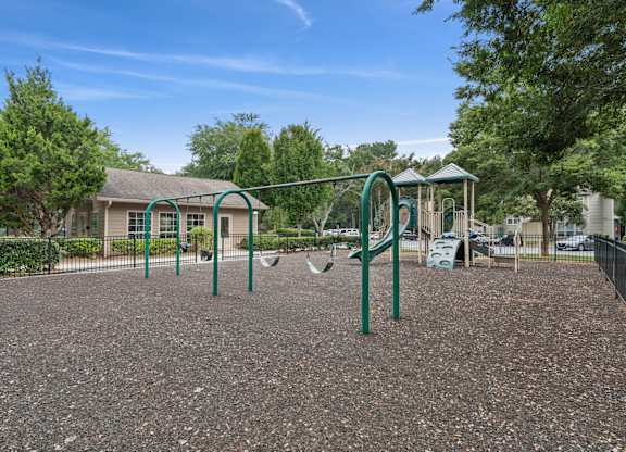 A playground with a swing set and a slide.