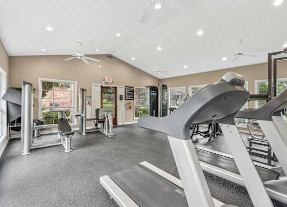 A gym with treadmills, weights, and exercise equipment.