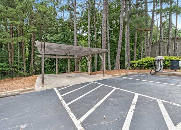 A parking lot with a wooden structure in the middle.