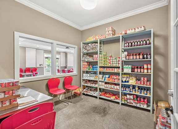 A room with a pantry and a dining table.