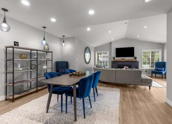 a living room with a table and chairs