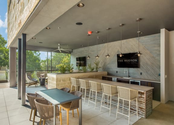 a bar with chairs and a table in front of a window