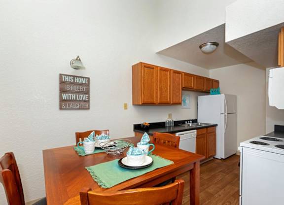 A kitchen with a sign that says "This home is filled with love and laughter.".