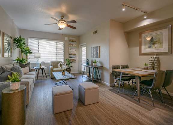 an open living room and dining room with a ceiling fan