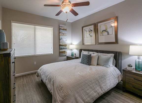 a bedroom with a large bed and a ceiling fan