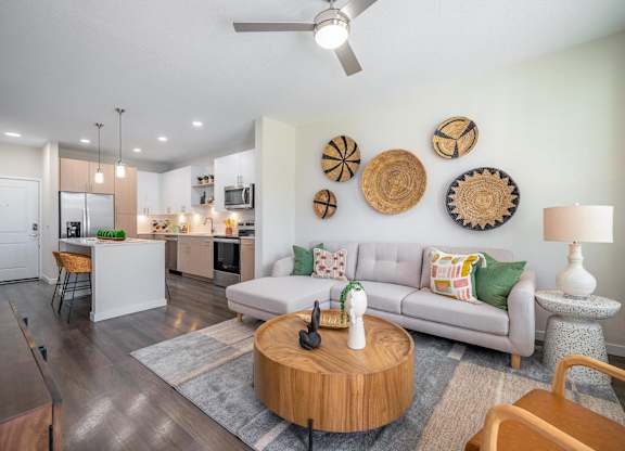 A modern living room with a grey couch and wooden coffee table.