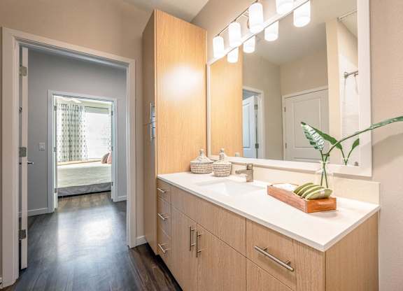A bathroom with a vanity and a mirror.