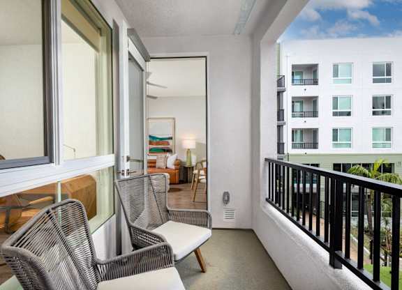 A balcony with a chair and a table.