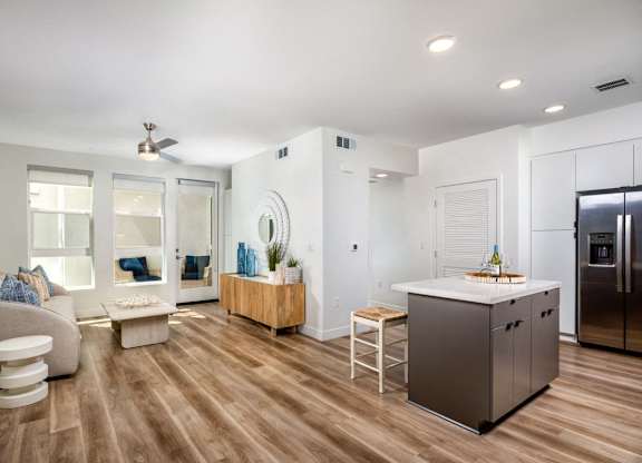 A modern kitchen with a refrigerator, stove, and island.