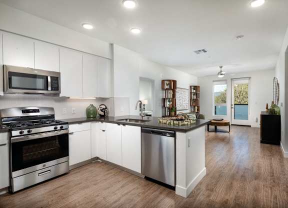 A kitchen with white cabinets and stainless steel appliances.