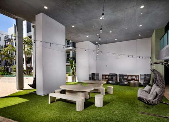 A modern outdoor seating area with a white and green color scheme.