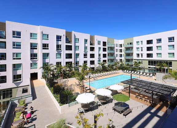 A large white building with a pool in the middle of it.
