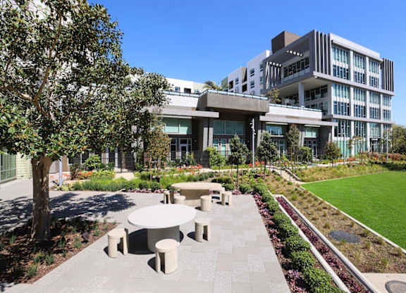 A modern building with a green lawn in front.