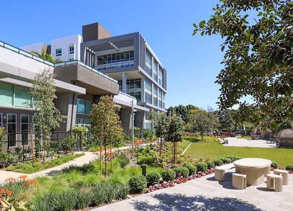A modern building with a green lawn in front.
