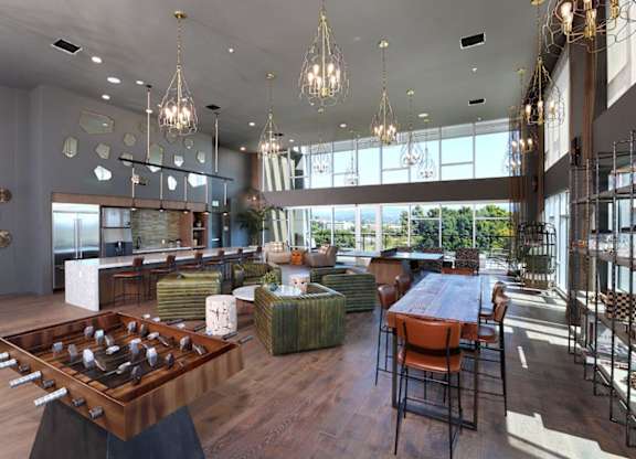 A modern dining room with a large wooden table and chairs.