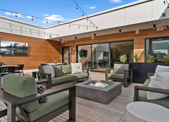 A patio with a fire pit and seating area at Cru at Willows Apartments, Redmond, Washington